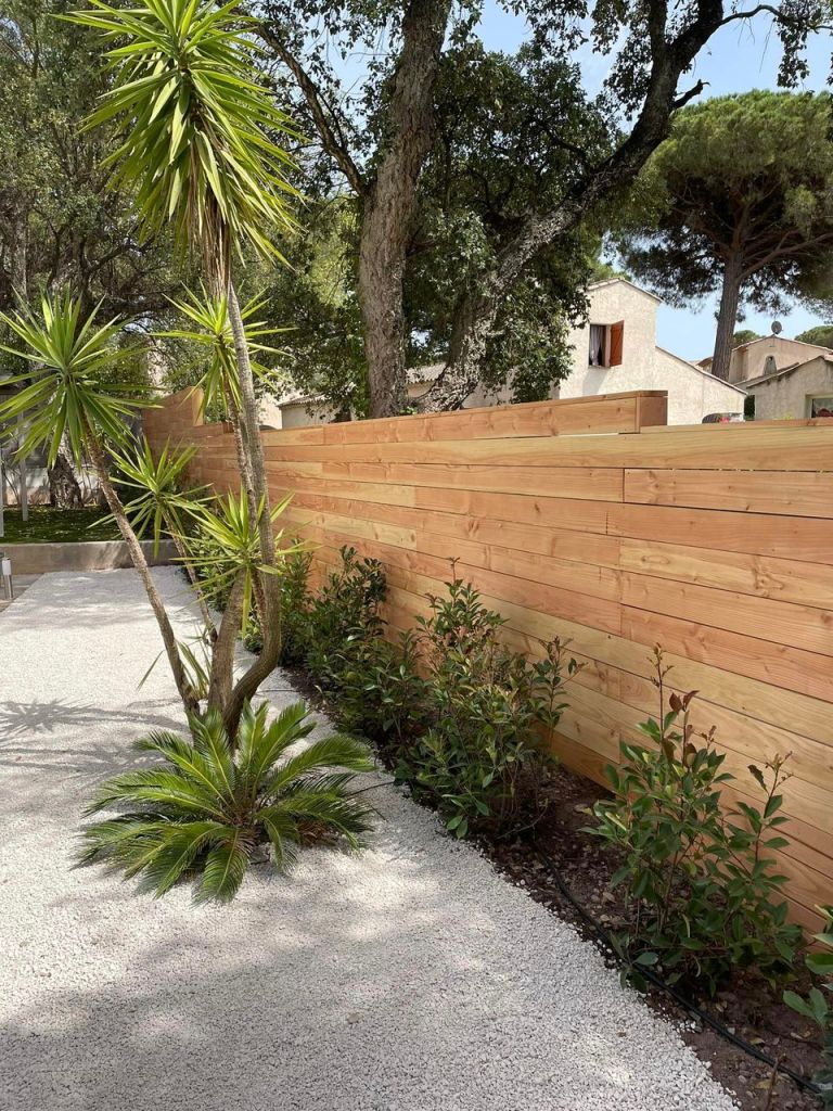 Aménagement Jardin Saint-Raphaël 83700 Paysagiste. Clôture en bois sur mesure, gravier blanc et plantations haie.